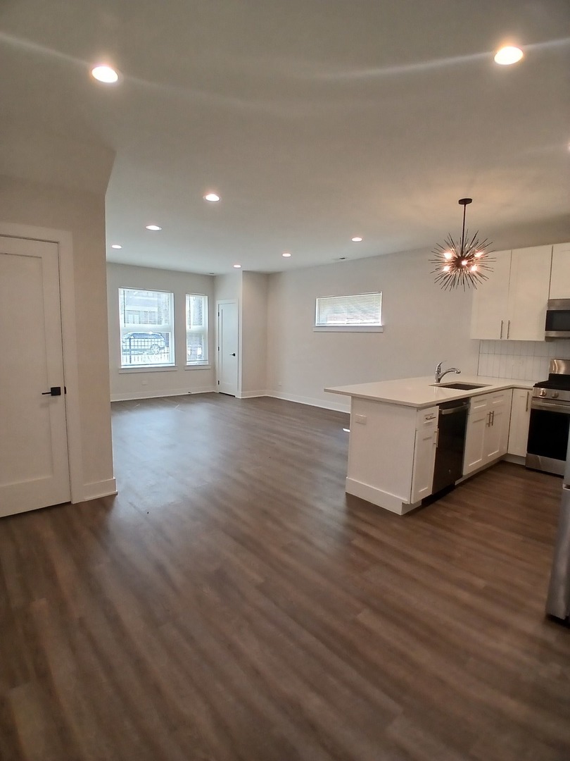 4608 South Indiana Avenue, Unit 1 Chicago, IL 60653 - Photo 10 of 24 a view of kitchen with sink and wooden floor
