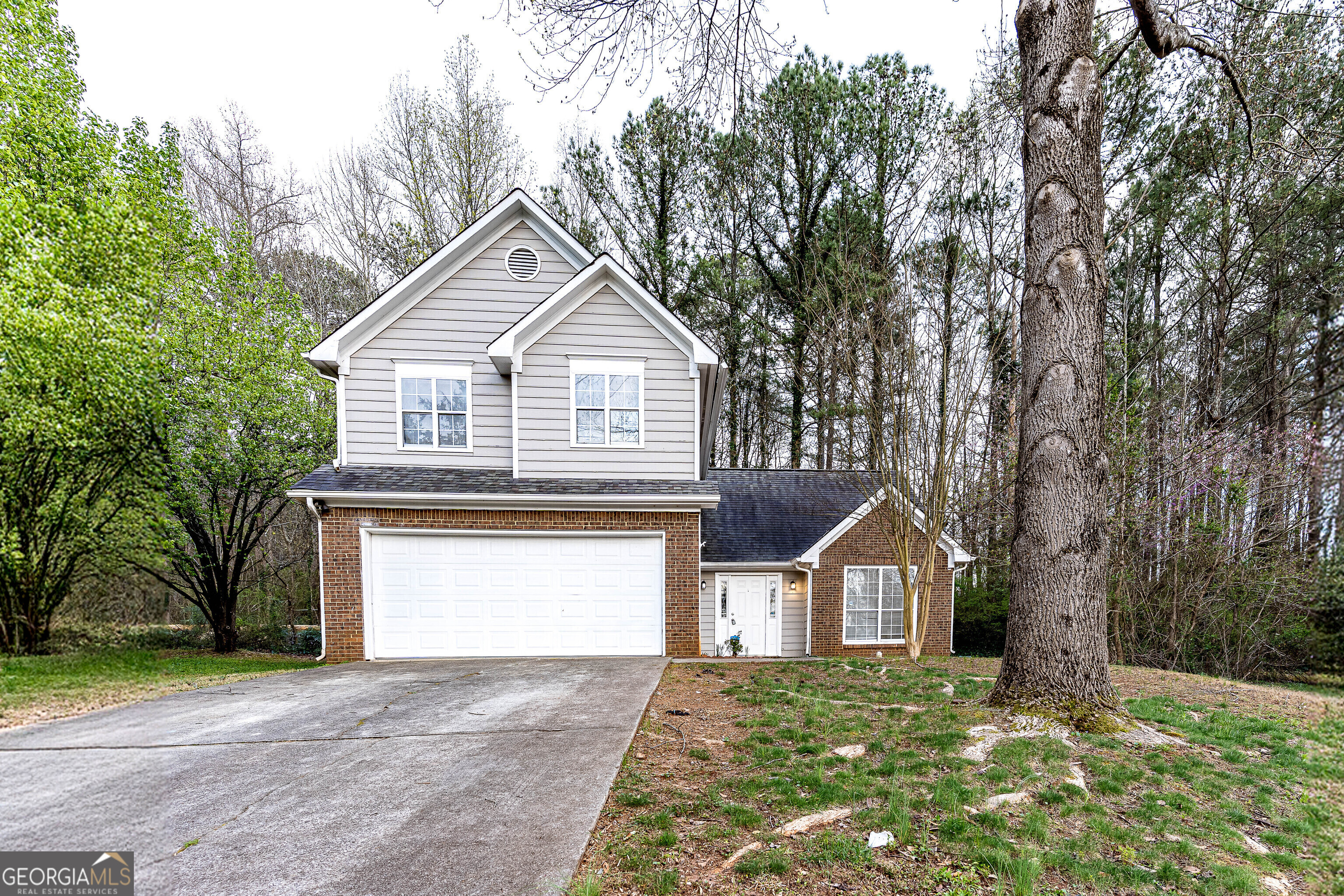 a front view of a house with a yard and garage