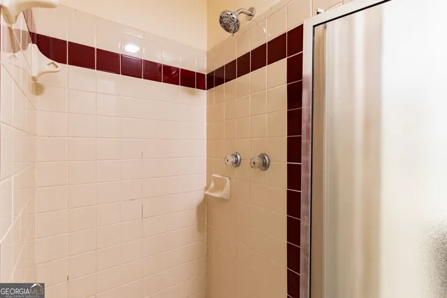 a bathroom with a tub shower and vanity