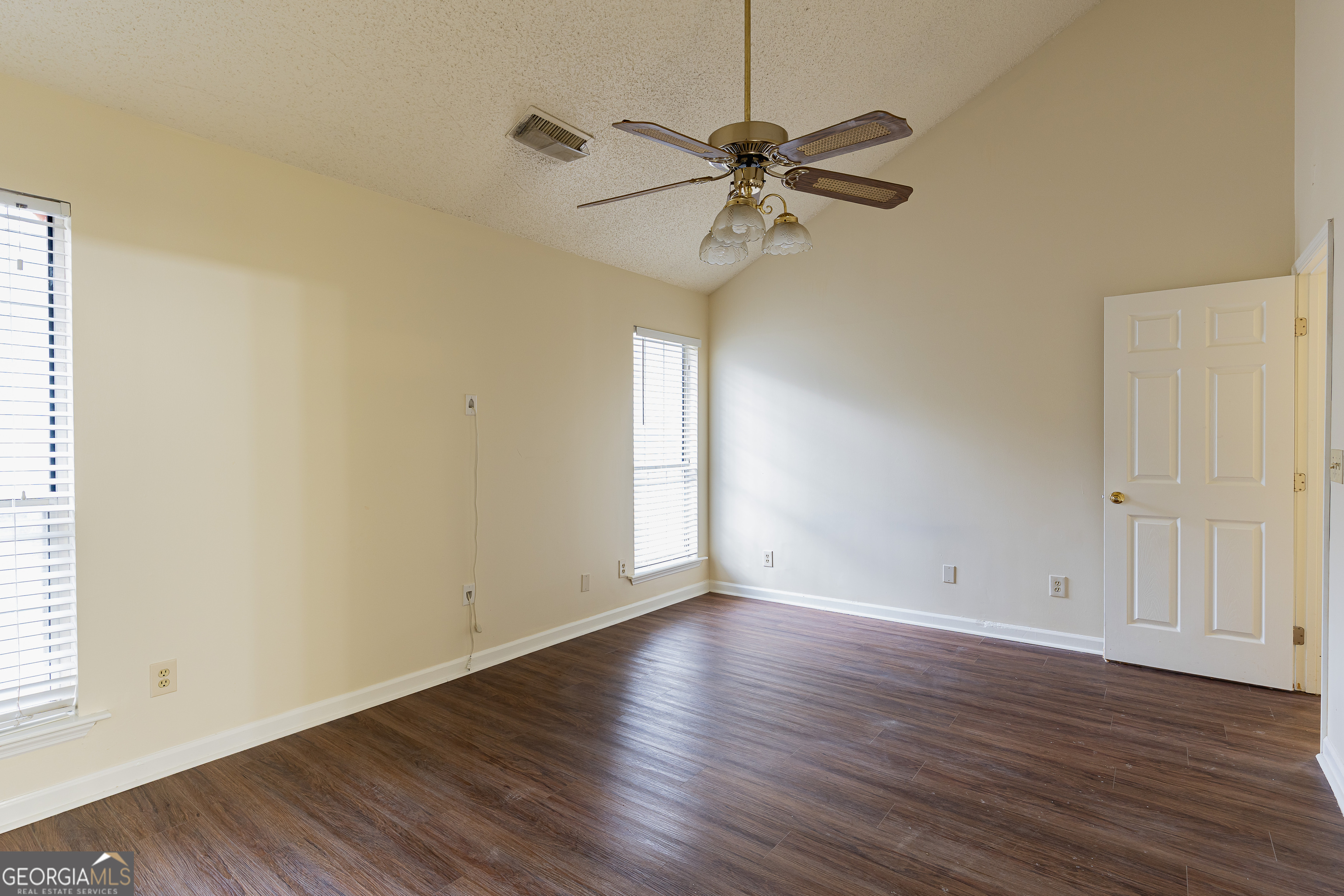 3821 Rex Mill Square Rex, GA 30273 - Photo 31 of 68 an empty room with wooden floor fan and windows
