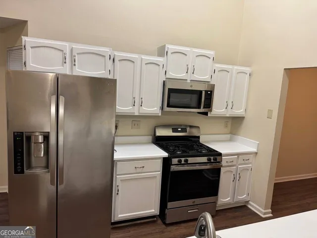 a kitchen with a refrigerator stove and microwave