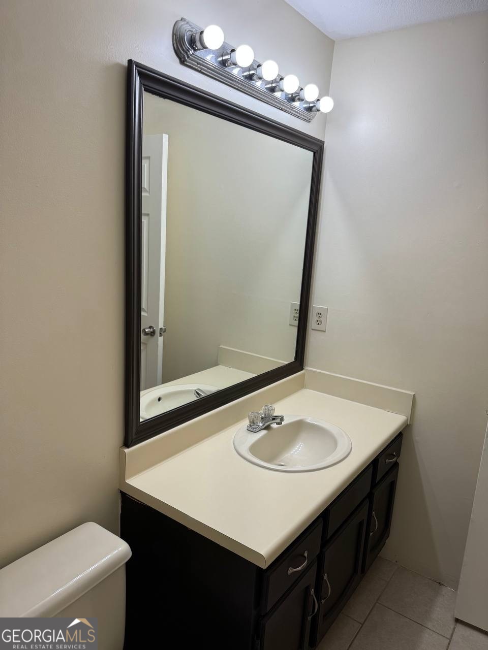 3821 Rex Mill Square Rex, GA 30273 - Photo 56 of 68 a bathroom with a sink a mirror and a toilet