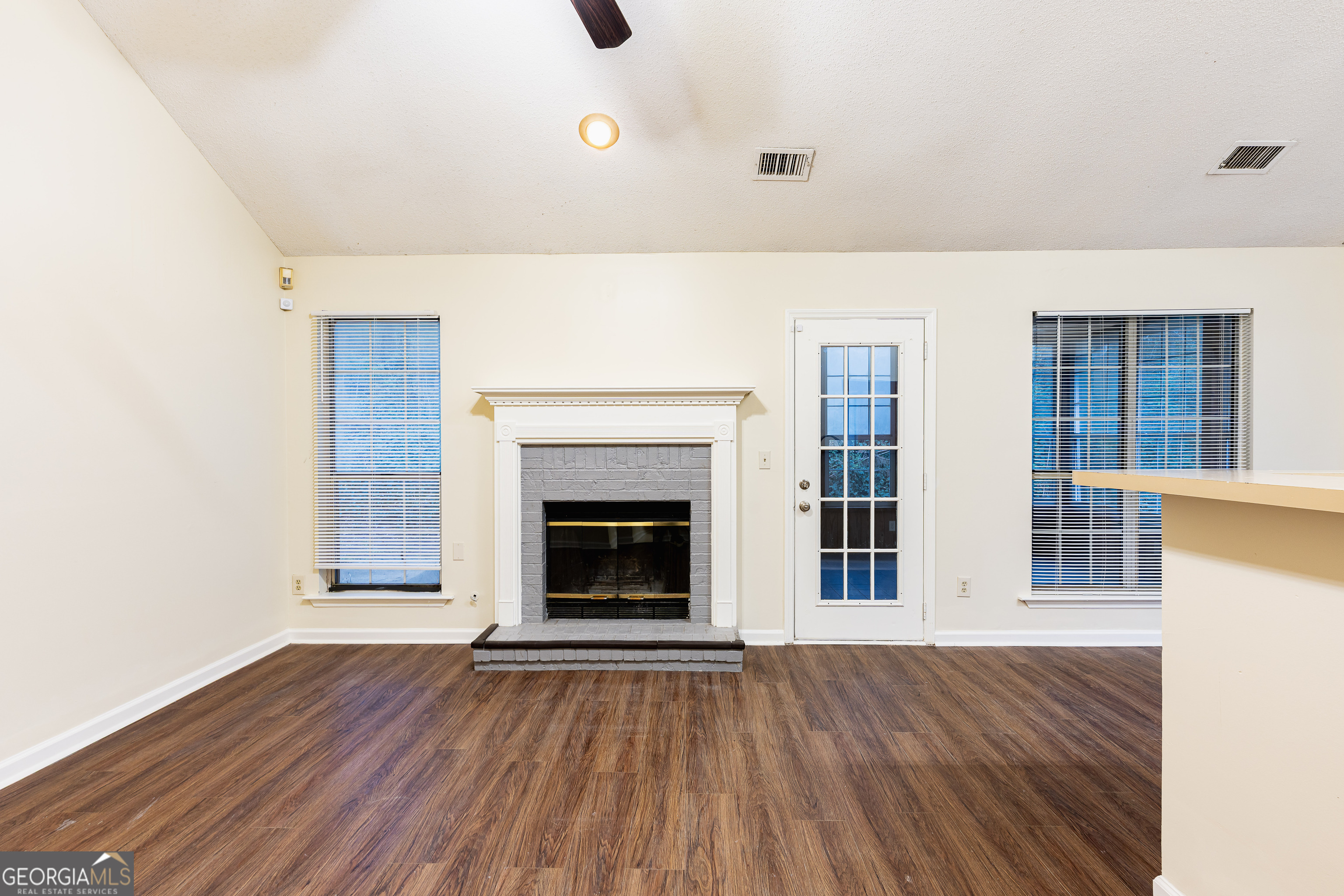 3821 Rex Mill Square Rex, GA 30273 - Photo 6 of 68 a view of an empty room with wooden floor and a window