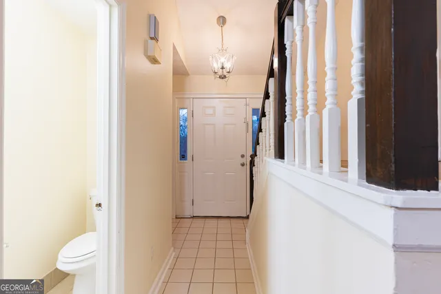 a view of staircase with wooden floor and white walls