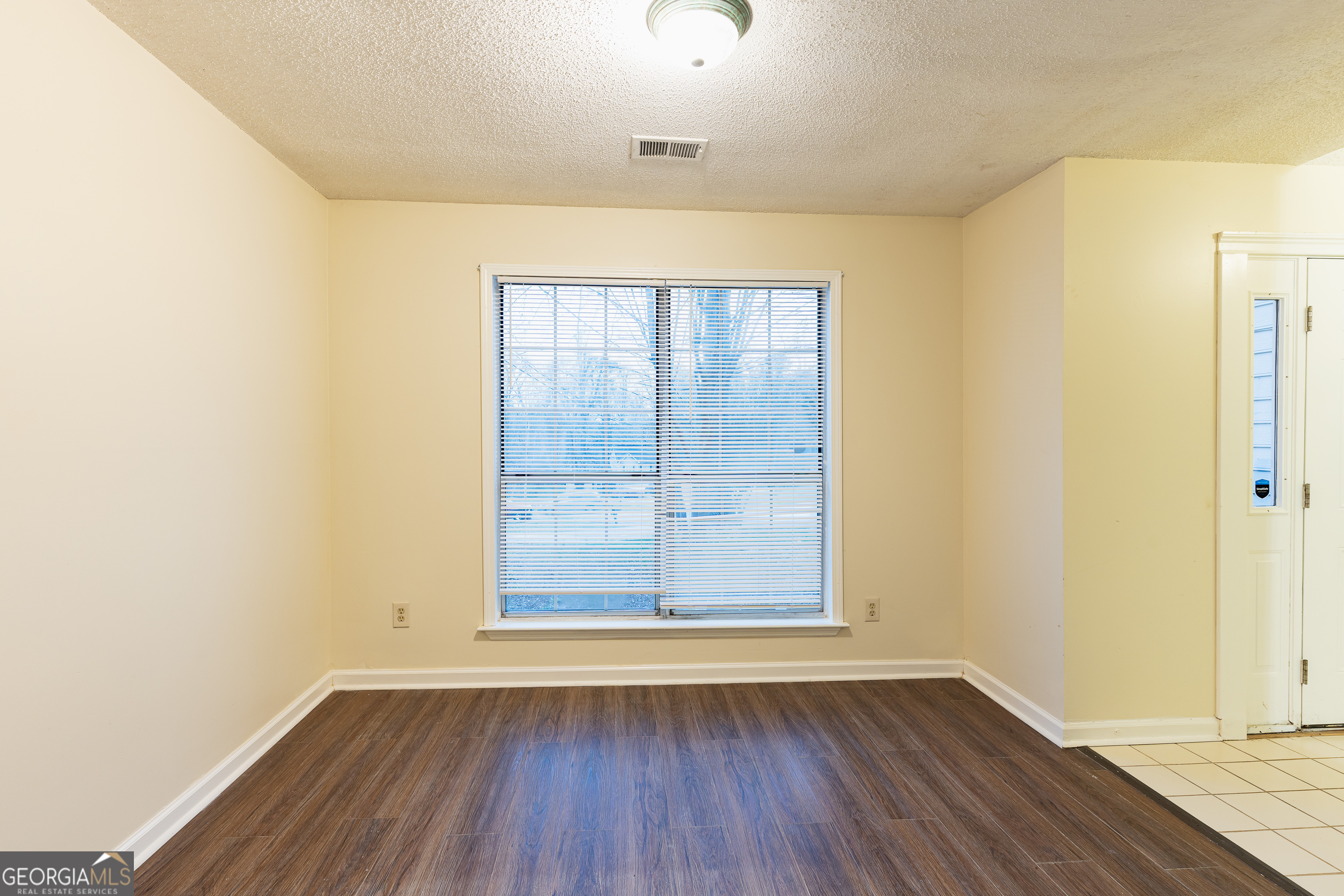 3821 Rex Mill Square Rex, GA 30273 - Photo 9 of 68 an empty room with wooden floor and windows