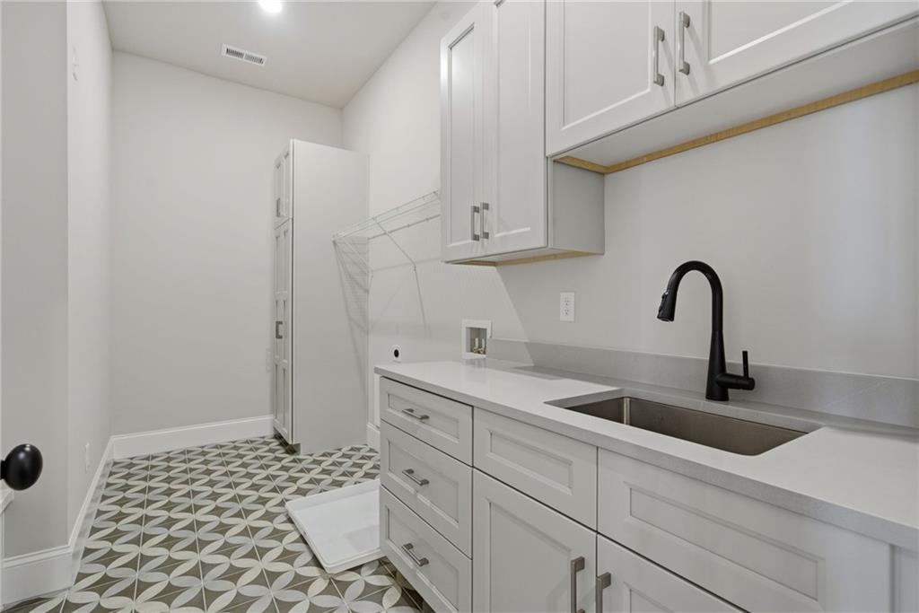 5364 Price Road Gainesville, GA 30506 - Photo 27 of 59 a kitchen with a sink and cabinets