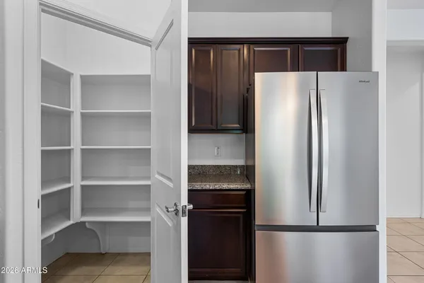 a metallic refrigerator freezer and a refrigerator in a kitchen