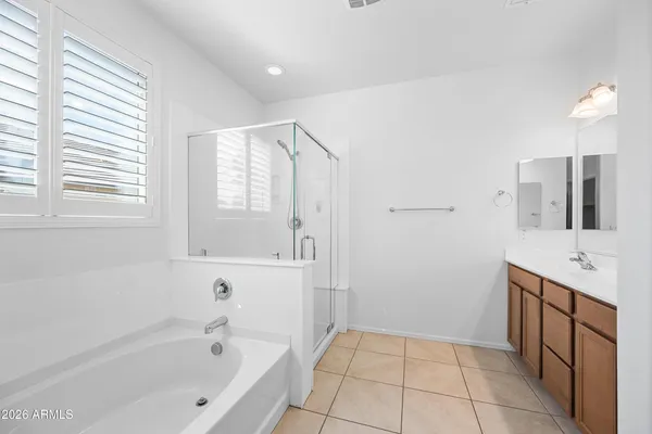 a bathroom with a bathtub sink and mirror