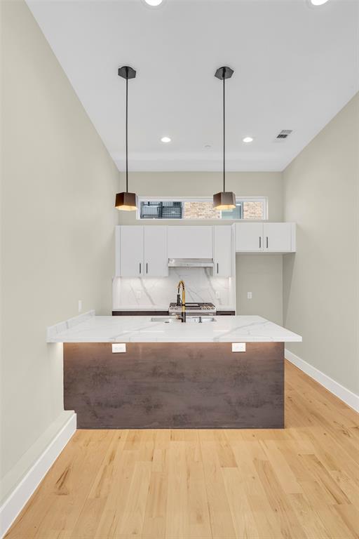 2214 Annex Avenue, Unit 106 Dallas, TX 75204 - Photo 7 of 19 a view of kitchen center island and stainless steel appliances