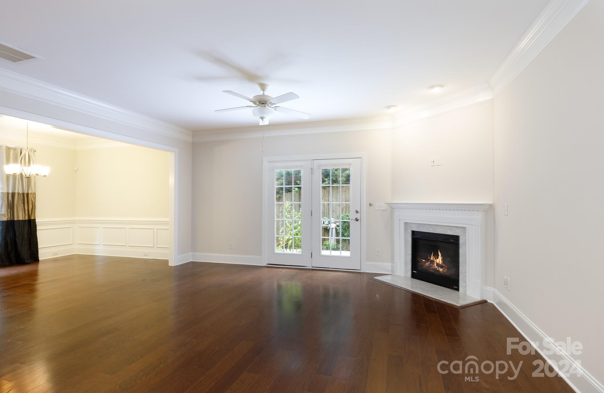 921 Ospre Lane Fort Mill, SC 29708 - Photo 3 of 17 a view of an empty room with wooden floor fireplace and a window