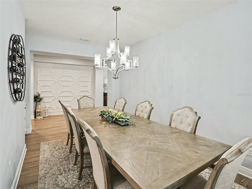 5270 Obsidian Gate Road Mount Dora, FL 32757 - Photo 16 of 50 a dining room with furniture and chandelier