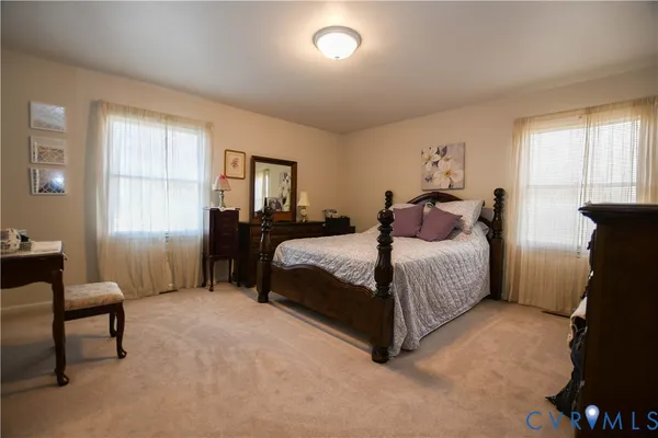 a bedroom with a bed and a chair