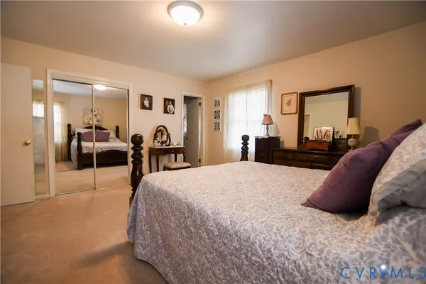 a bed room with a bed and a large mirror