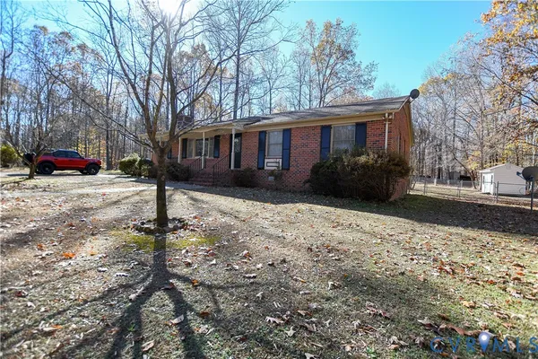 a front view of a house with a yard covered in snow