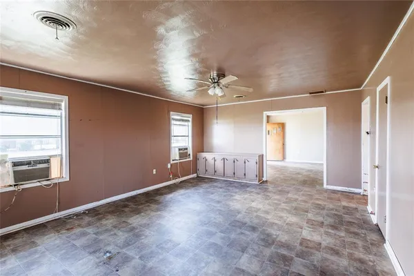 a view of a livingroom with a ceiling fan and window