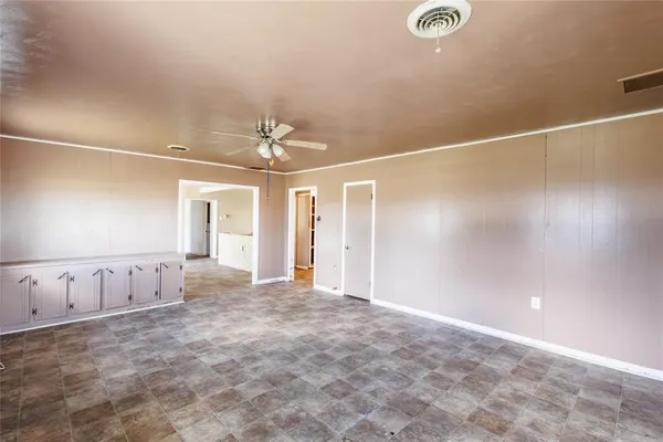 an empty room with windows and pillars in it