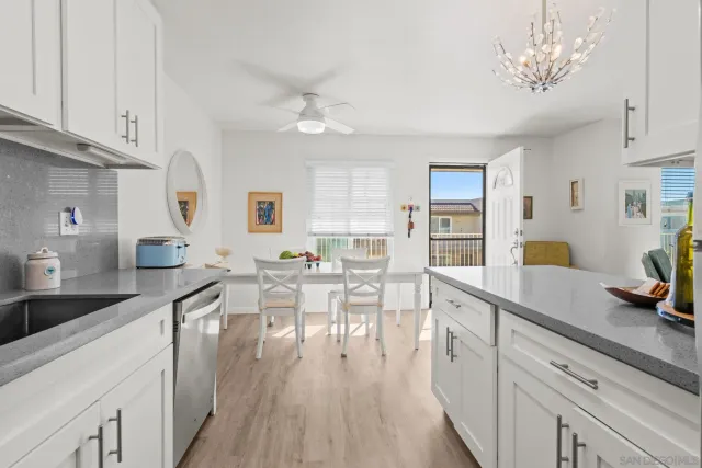 a very nice looking kitchen with granite countertop a large counter space a sink appliances and cabinets