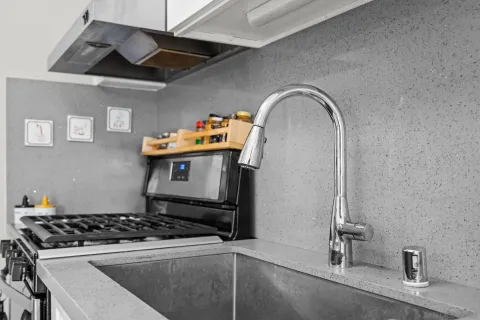 a stove top oven sitting inside of a kitchen