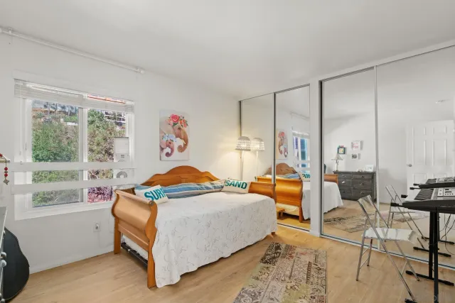 a bedroom that has a bed and a table in it