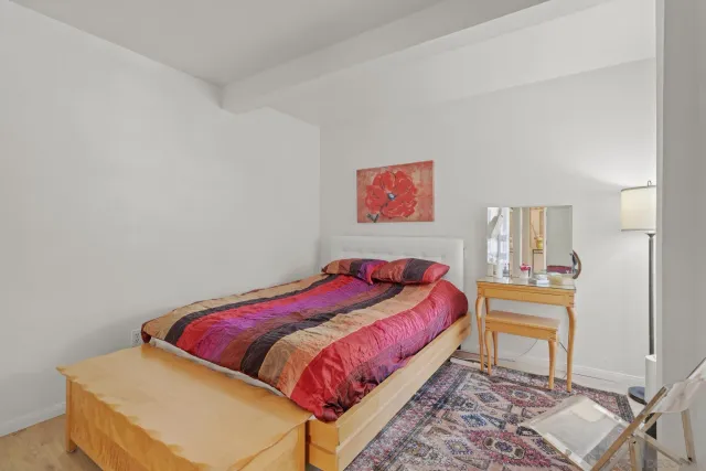 a bedroom with a bed and a table in it