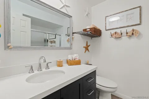 a bathroom with a sink mirror and vanity