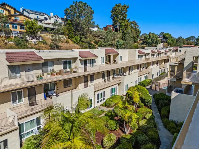 a view of a building with a garden in the background