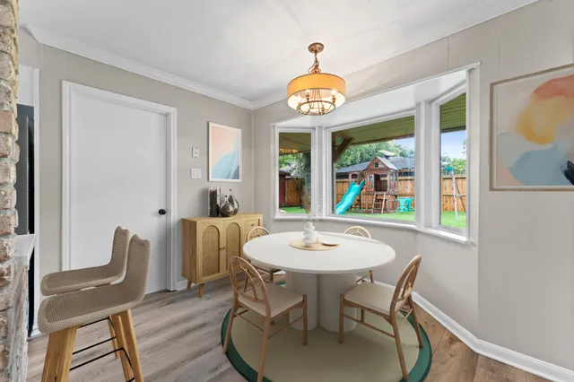 a view of a dining room with furniture window and wooden floor
