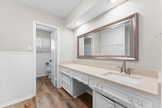 a spacious bathroom with a double vanity sink a mirror and a bathtub
