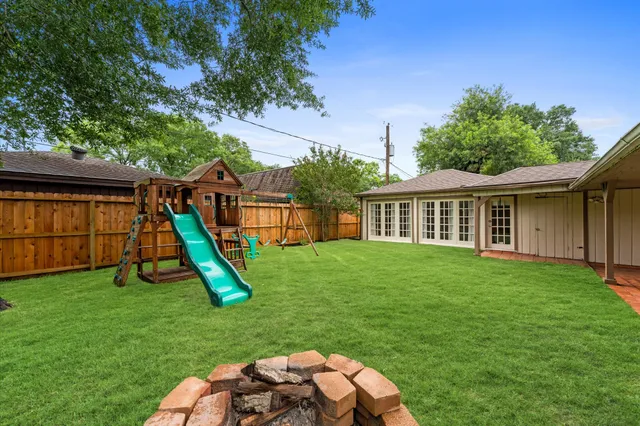 a view of a house with a backyard and a slide