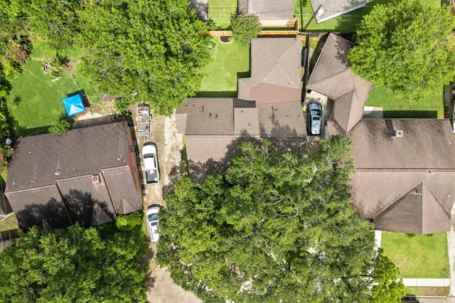 an aerial view of a house with a yard and garden