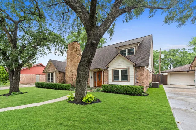 a front view of house with yard and green space