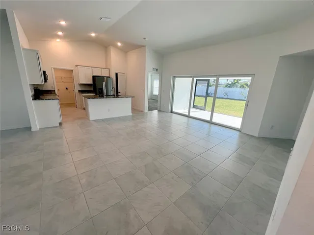 a view of open kitchen with a sink and refrigerator
