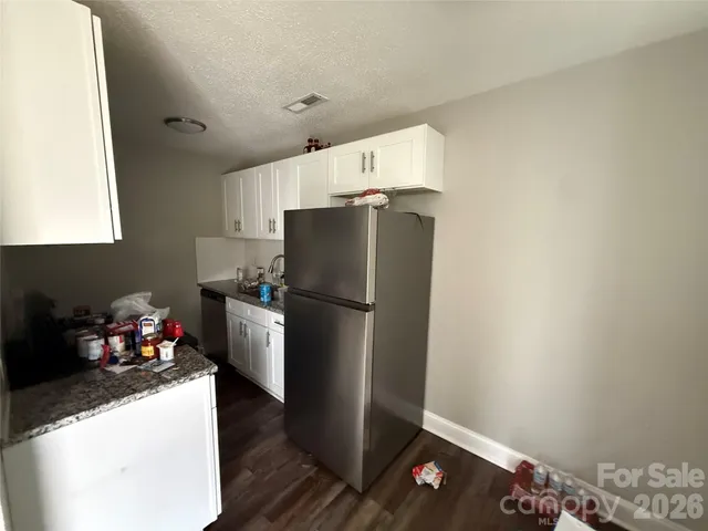 a kitchen with a refrigerator and a stove