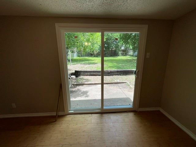 845 Rumfield Road White Settlement, TX 76108 - Photo 15 of 19 a view of an empty room with wooden floor and a window