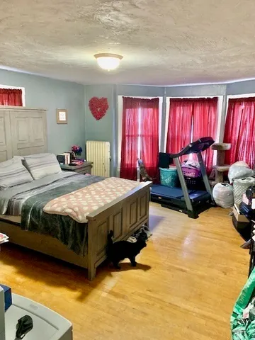 a bedroom with bed and window