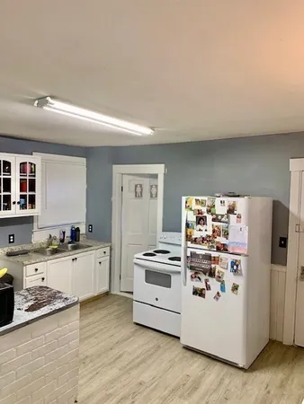 a kitchen with stainless steel appliances a stove a refrigerator and a stove