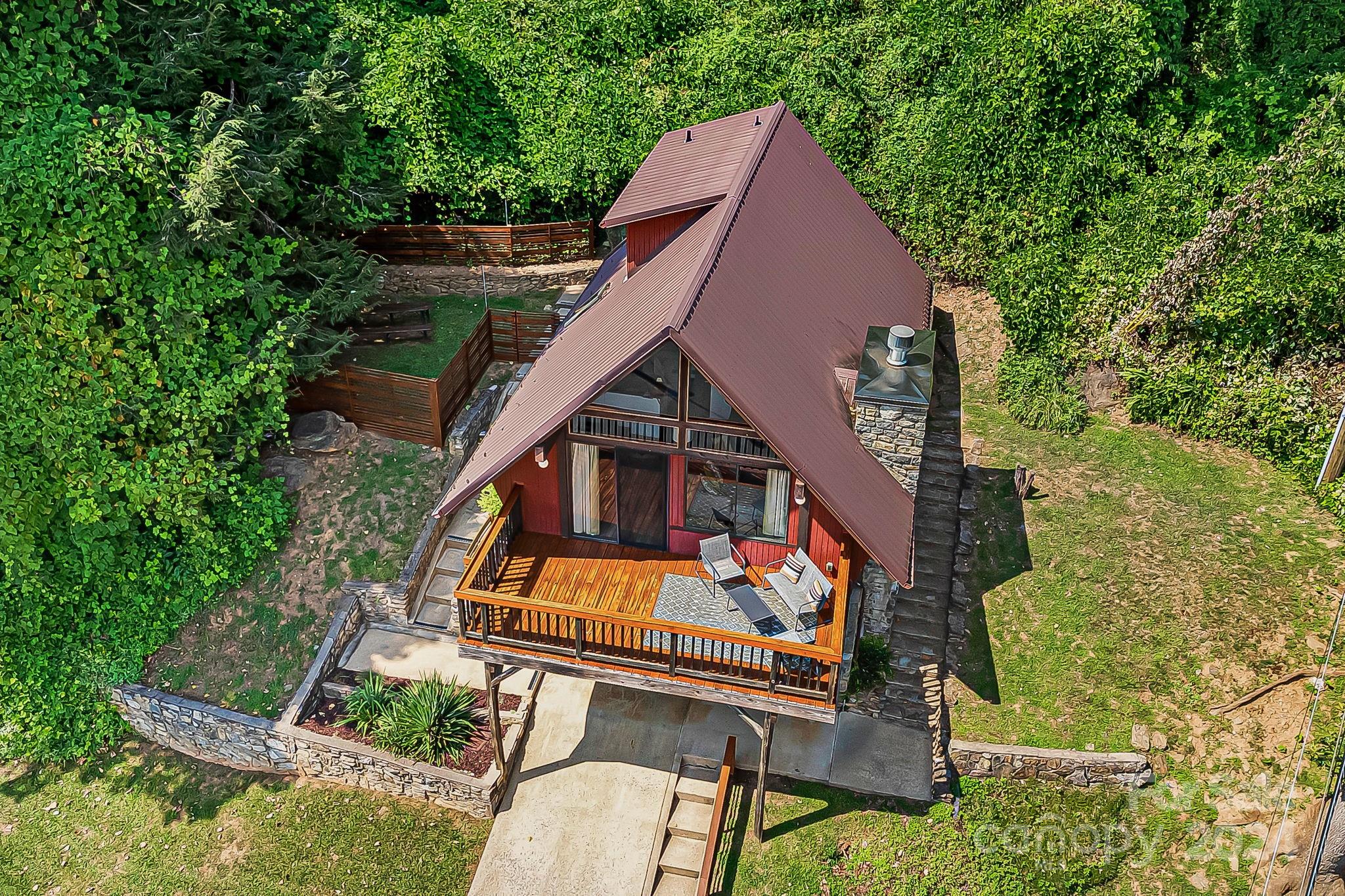 161 Spencer Street Clyde, NC 28721 - Photo 3 of 41 an aerial view of a house with swimming pool and furniture