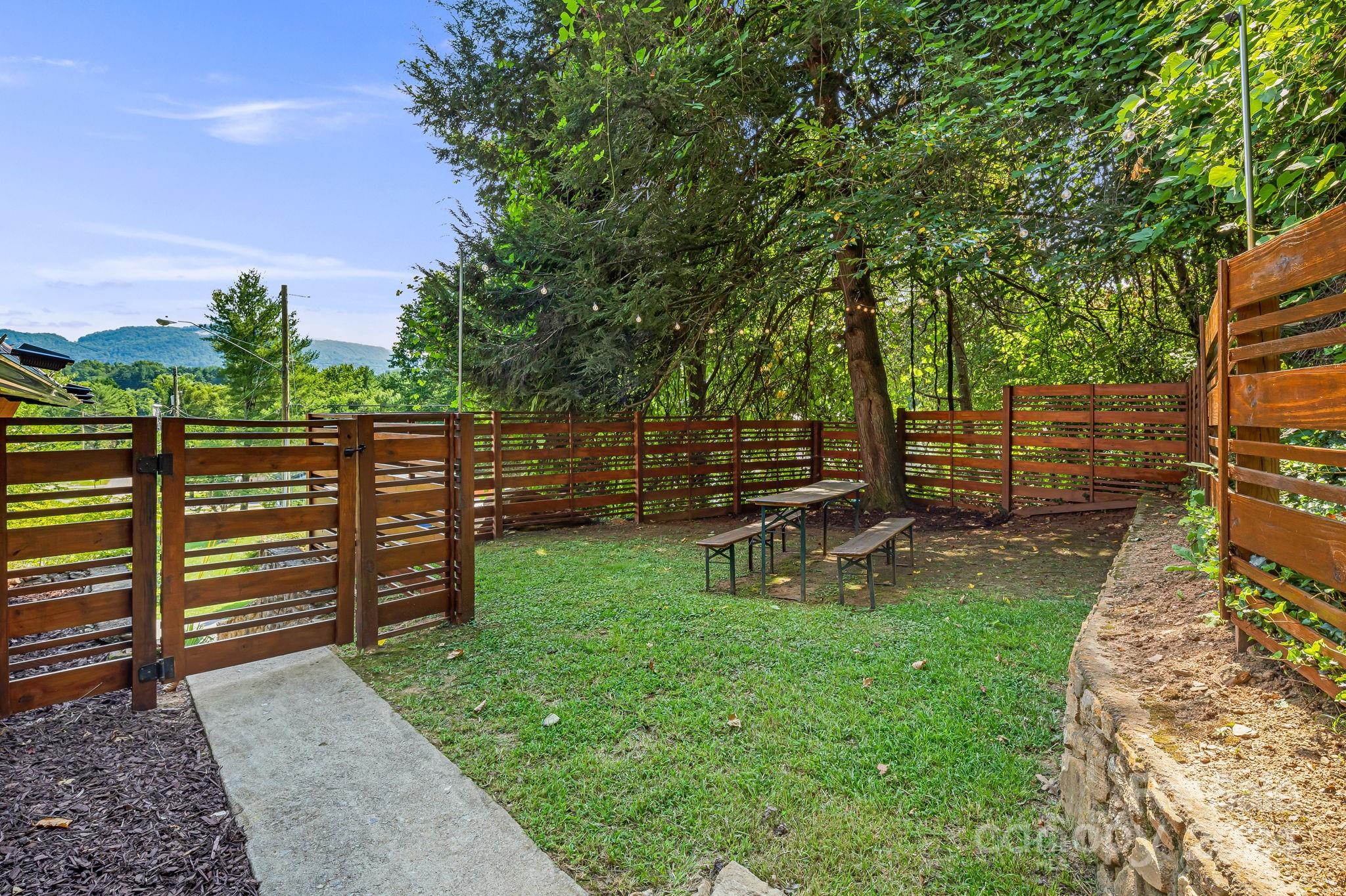 161 Spencer Street Clyde, NC 28721 - Photo 36 of 41 a view of a park with bench and trees