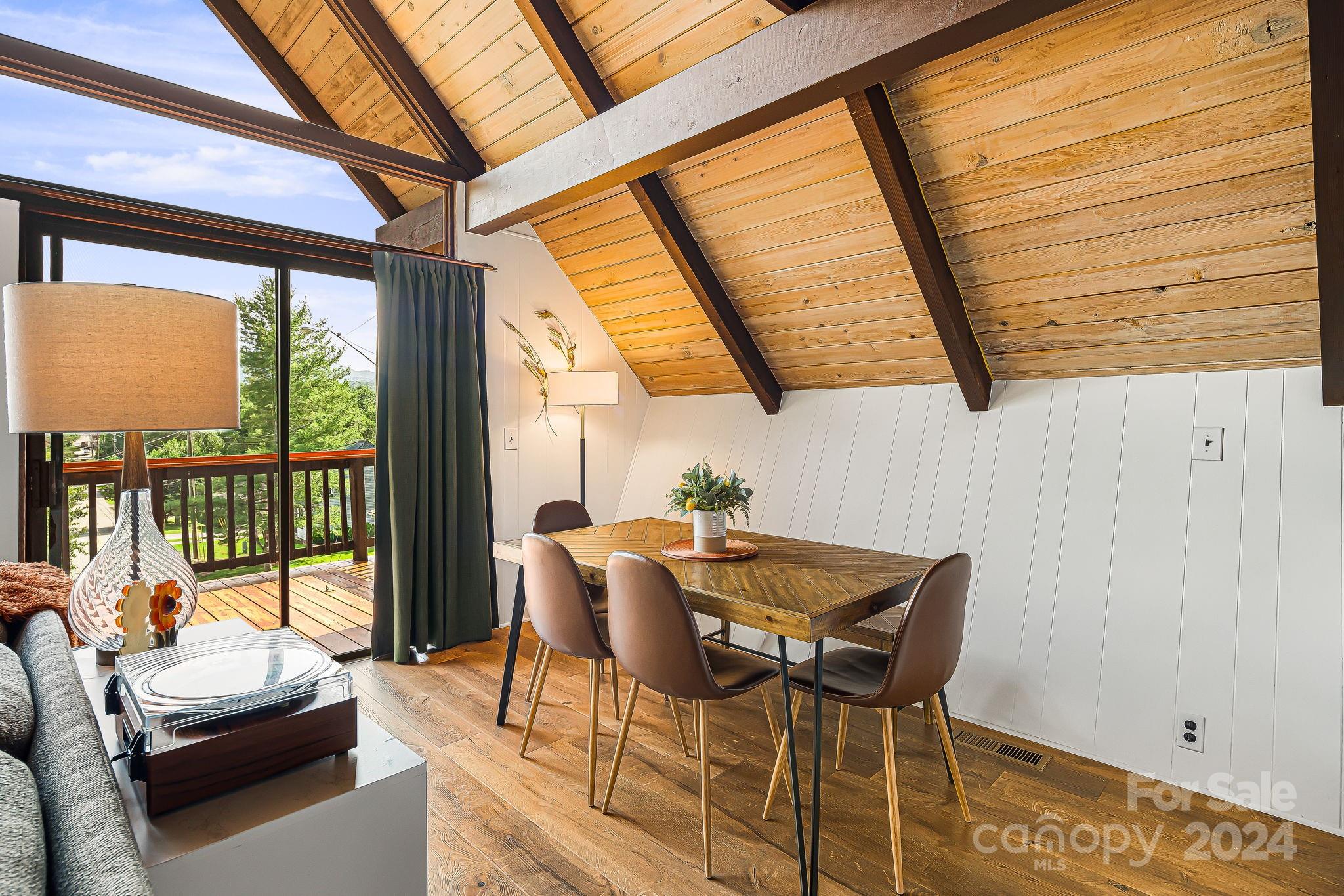 161 Spencer Street Clyde, NC 28721 - Photo 10 of 41 a dining room with furniture and a floor to ceiling window