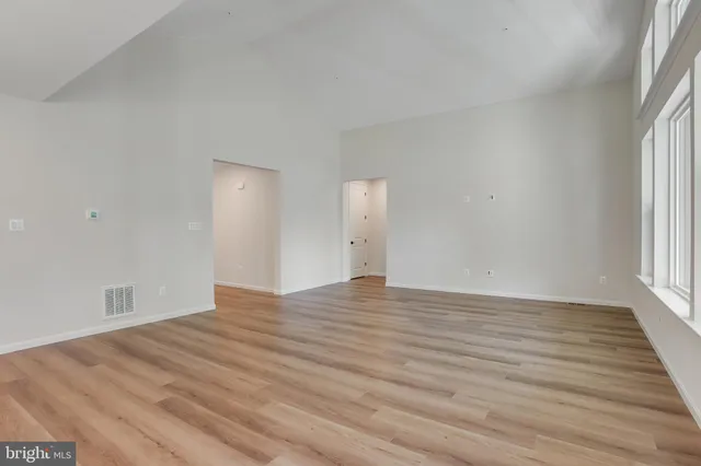 a large kitchen with kitchen island a sink stainless steel appliances and cabinets