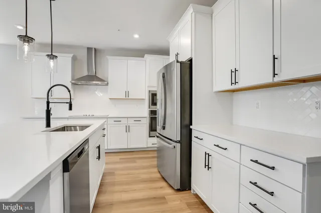 a bathroom with a double vanity sink a mirror and a bathtub