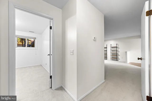 a view of a hallway with wooden floor and windows