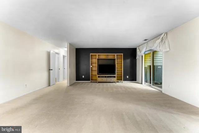 a view of an empty room with a fireplace