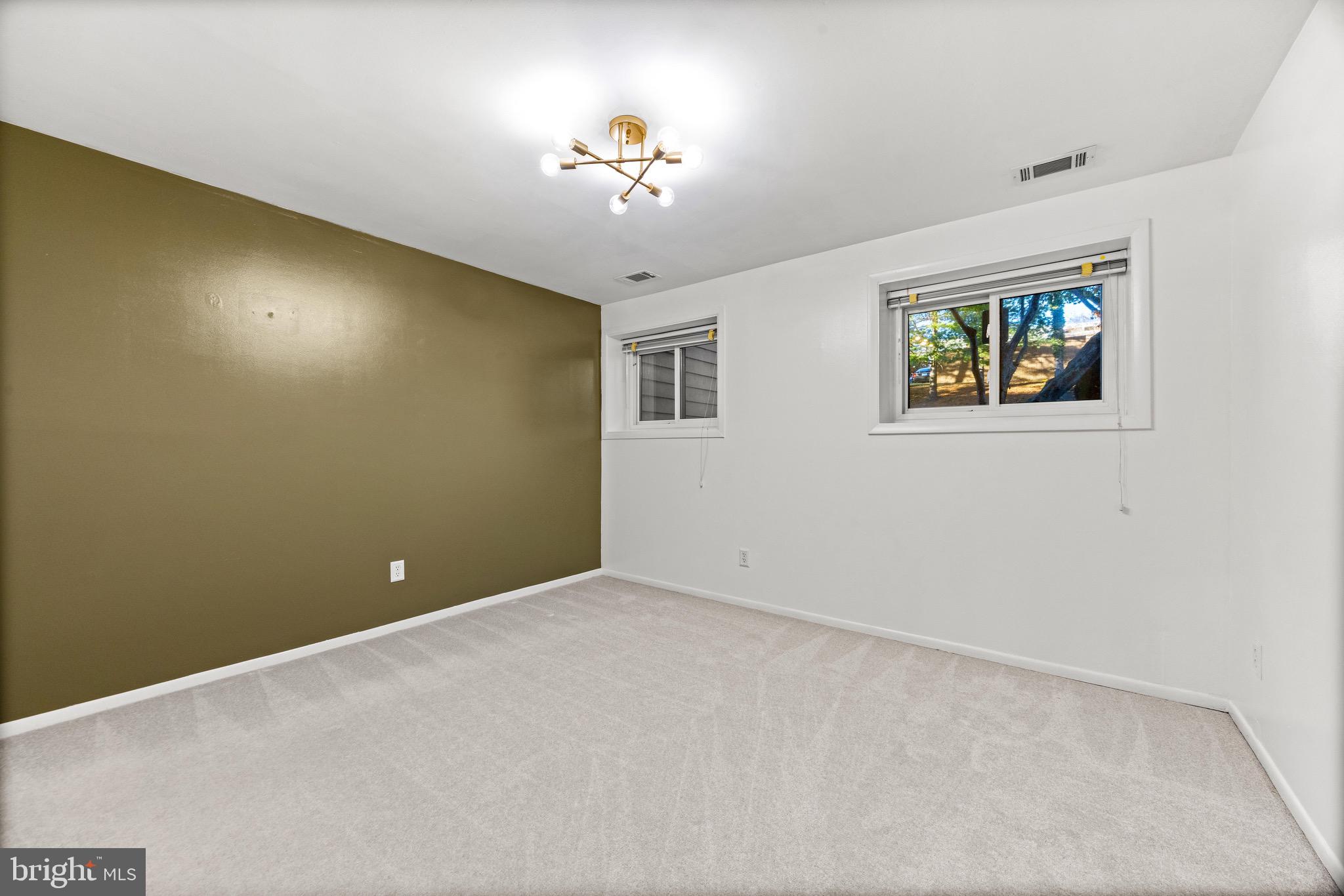 6909 Jones View Drive, Unit 1A Baltimore, MD 21209 - Photo 22 of 30 a view of an empty room with a chandelier fan
