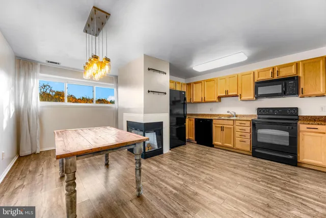 a kitchen with stainless steel appliances a stove a refrigerator and a sink