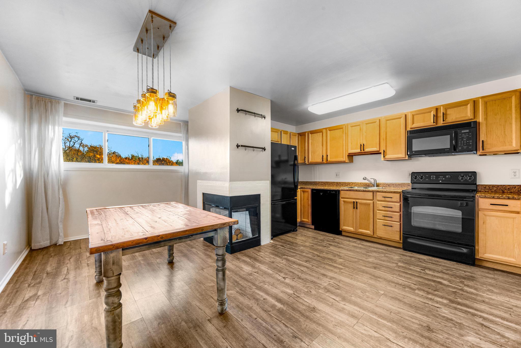 6909 Jones View Drive, Unit 1A Baltimore, MD 21209 - Photo 4 of 30 a kitchen with stainless steel appliances a stove a refrigerator and a sink