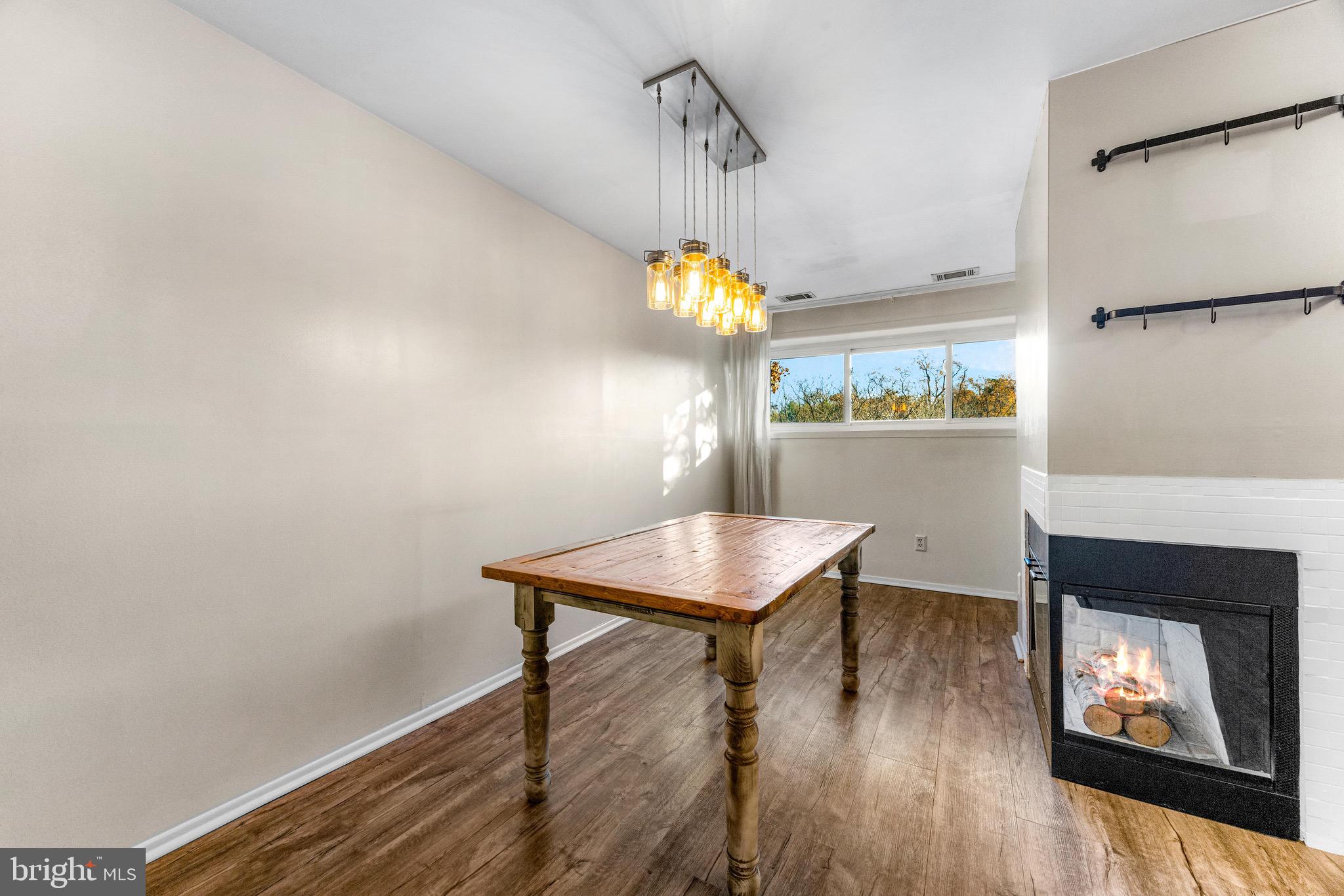 6909 Jones View Drive, Unit 1A Baltimore, MD 21209 - Photo 9 of 30 a view of a dining room with furniture and wooden floor
