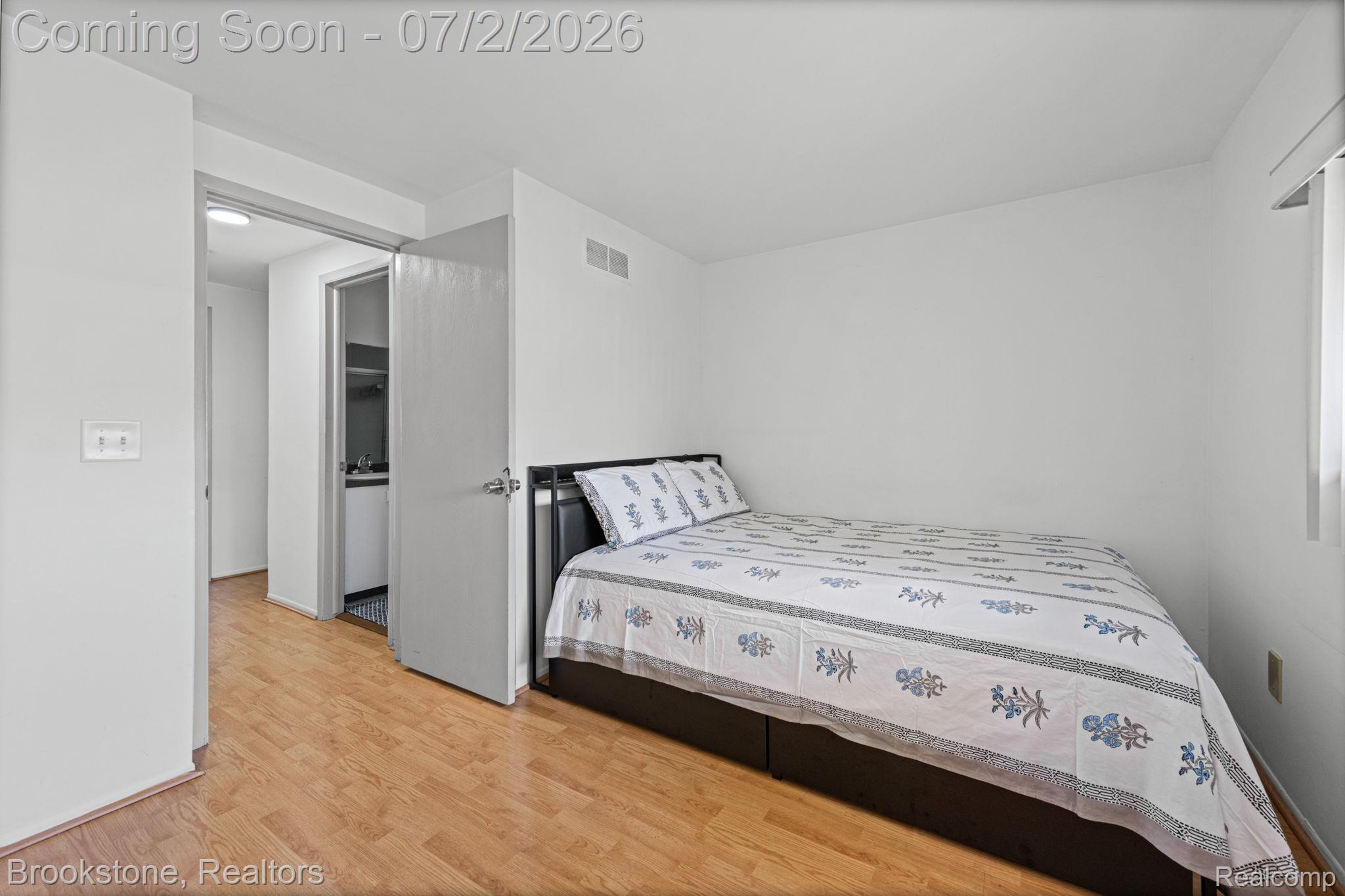 1925 Nicholas Court Warren, MI 48092 - Photo 17 of 26 Bedroom featuring wood-finish flooring and white painted walls