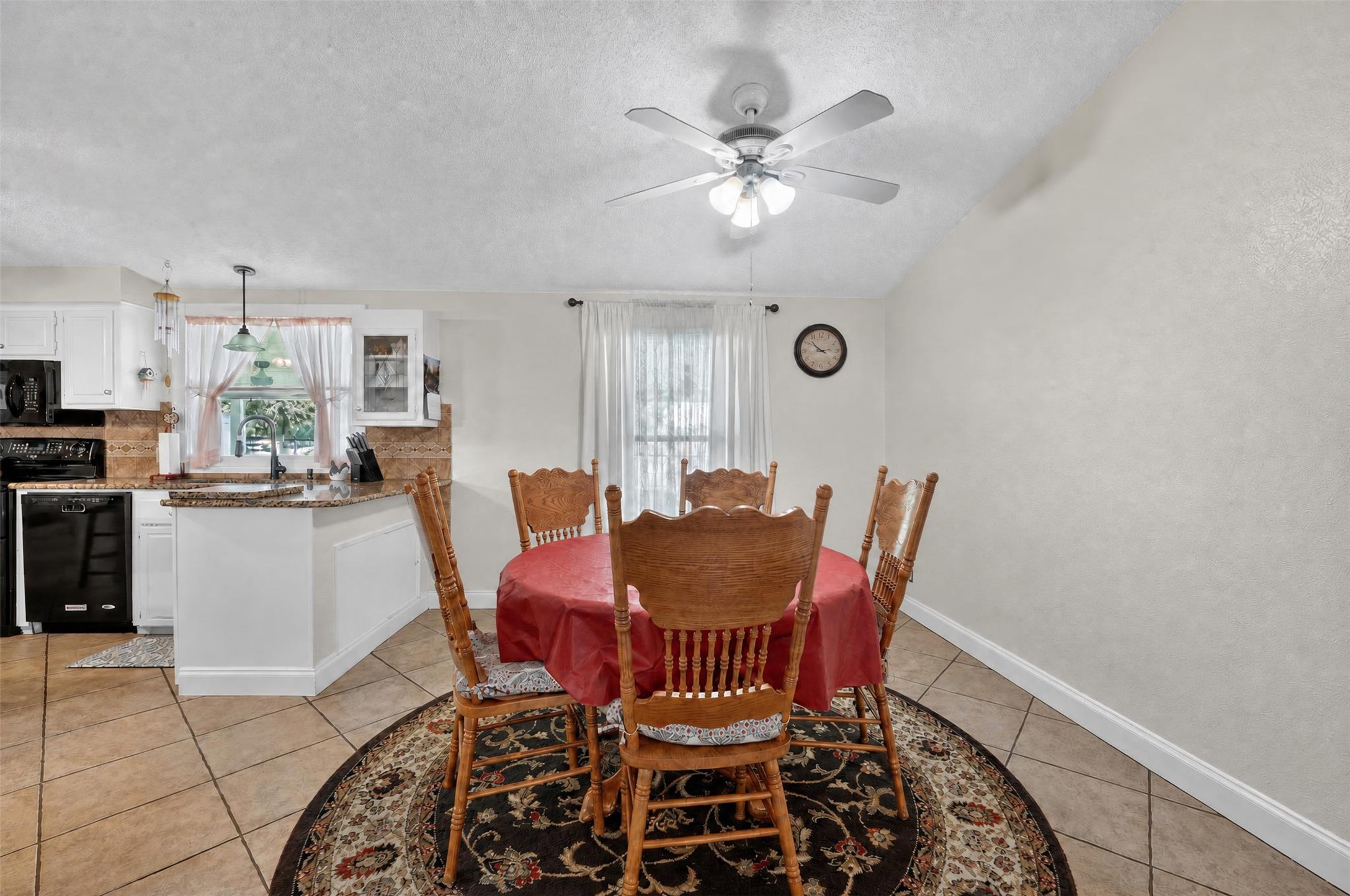 317 Rae Lane Jarrell, TX 76537 - Photo 32 of 40 A quaint eat-in kitchen with granite counters and a charming dining area with vaulted ceilings.