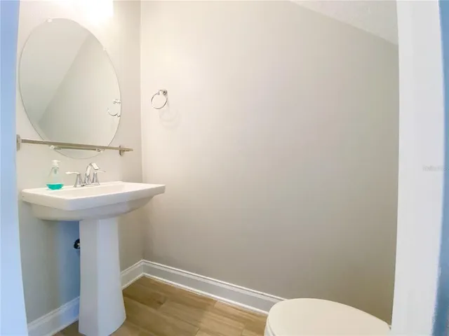 a bathroom with a granite countertop sink mirror toilet and bathtub